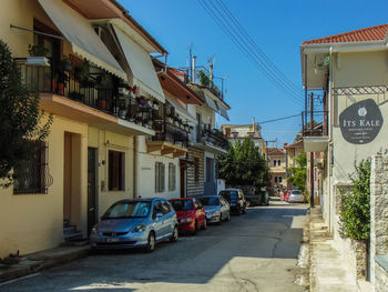 Cars on road by buildings in city