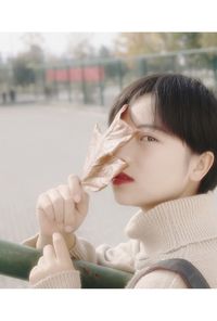 Close-up of baby hand holding leaf