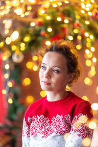 Portrait of girl in illuminated christmas tree