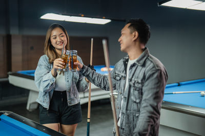 Side view of young woman drinking wine