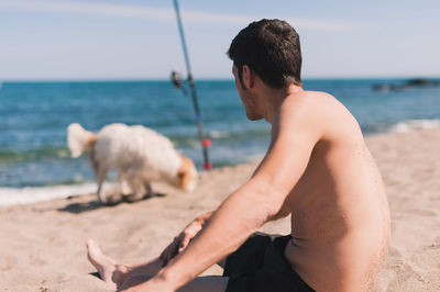 Young woman with animal on beach