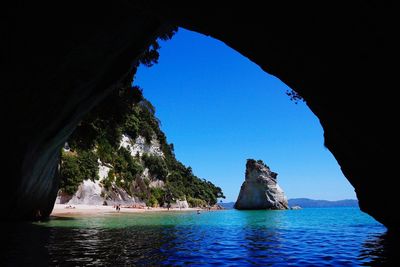 Rock formations in sea against sky