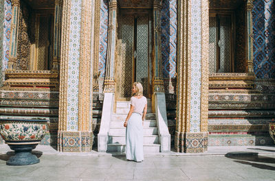 Full length rear view of woman at temple in city