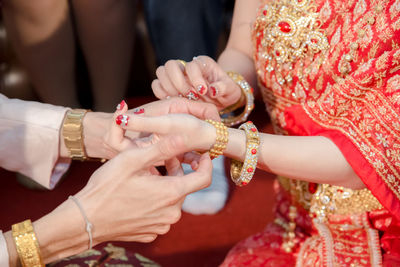 Midsection of couple during wedding ceremony