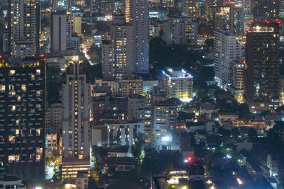 High angle view of illuminated buildings in city at night