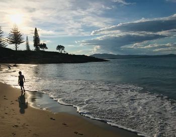 Man standing on beach against sky