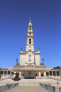 Low angle view of building against clear blue sky