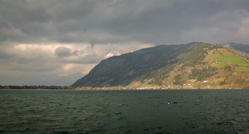 Scenic view of sea and mountains against sky