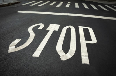 High angle view of arrow sign on road in city