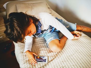 High angle view of girl using mobile phone at home