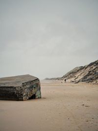 A ruin of a bunker hidden beneath the sand