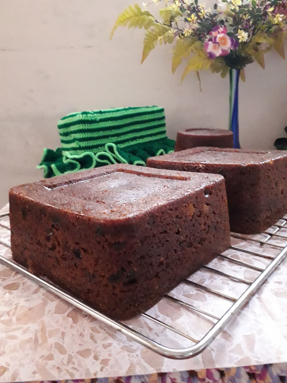 CLOSE-UP OF CAKE ON TABLE AGAINST WALL