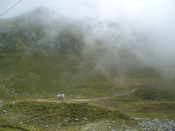 Scenic view of mountains in foggy weather