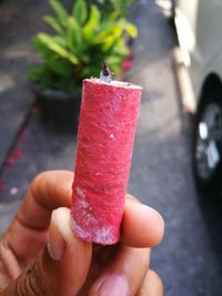 Close-up of hand holding ice cream cone