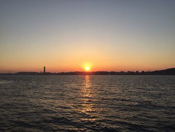 Scenic view of sea against clear sky during sunset