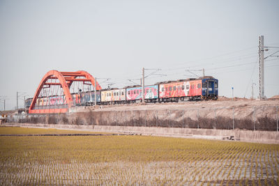 Train on field against clear sky