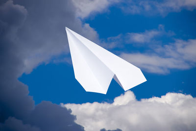 Low angle view of white flag against blue sky