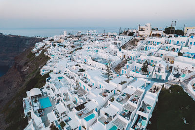 High angle view of townscape by sea against sky