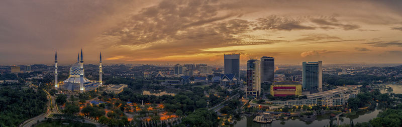 High angle view of modern buildings against sky during sunset