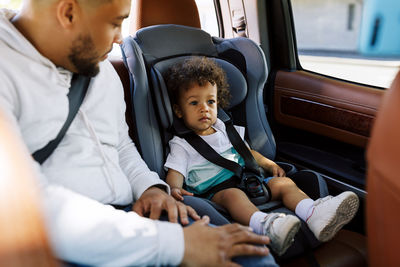 Father with son sitting in car