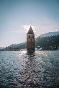 Tower amidst buildings against sky