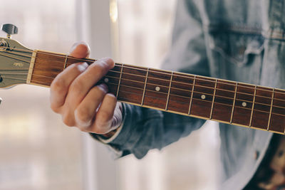 Close-up of person playing guitar
