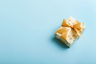 High angle view of gift box against blue background