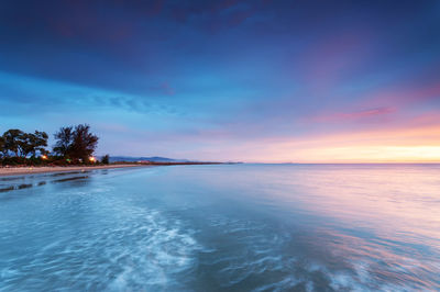 Scenic view of sea against sky at sunset