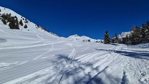 Snow covered mountain against blue sky