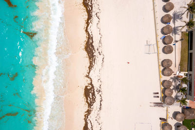 Aerial view of tropical sandy beach with turquoise ocean.