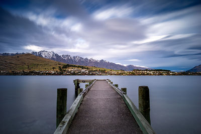 Pier over lake against sky