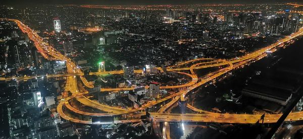 High angle view of illuminated city buildings at night