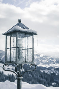 Close-up of snow on mountain against sky