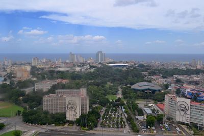 View of cityscape against cloudy sky