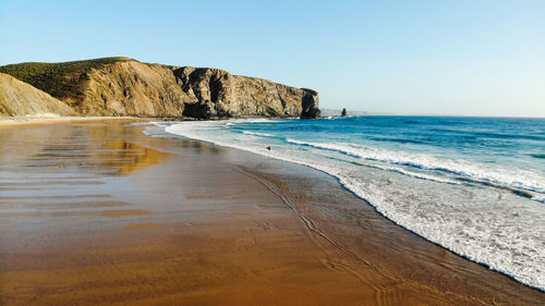 Scenic view of beach against clear sky