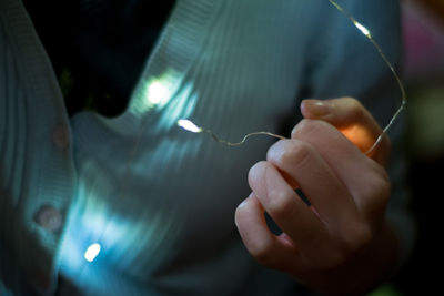 Close-up of hand holding illuminated lights