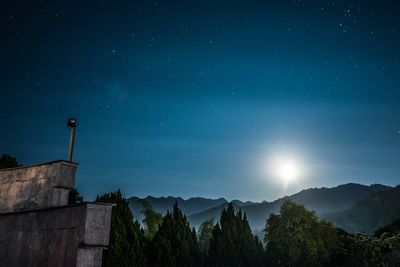 Scenic view of mountains against blue sky at night