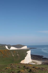 Scenic view of sea against blue sky