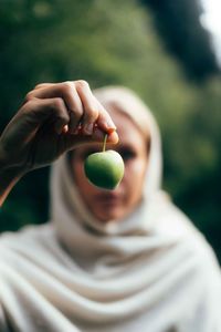 Midsection of woman holding egg