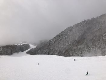 People skiing on snowcapped mountain