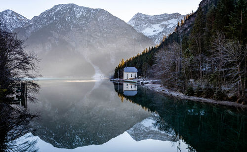 Scenic view of snowcapped mountains and lake during winter