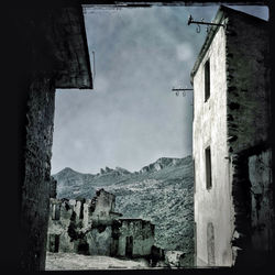 Buildings against cloudy sky