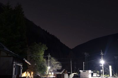 Low angle view of illuminated buildings against sky at night