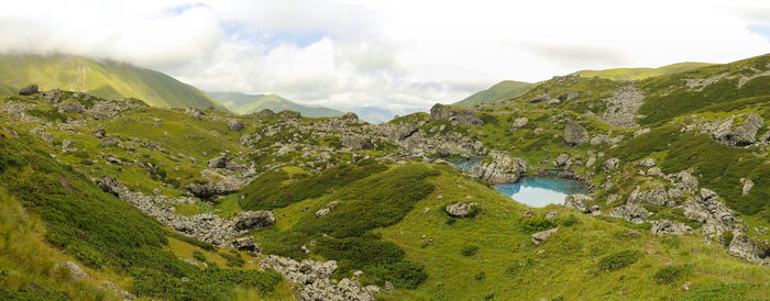 Scenic view of river and mountains against sky