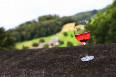 Close-up of red drink against sky