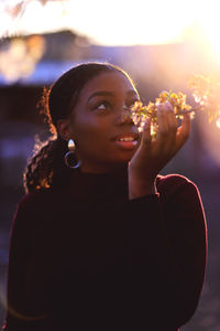 Portrait of a smiling young woman holding flower