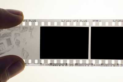 Close-up of man photographing on wall