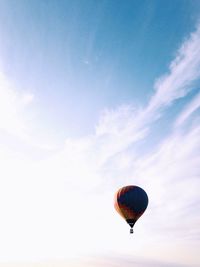 Hot air balloon flying against sky during sunset