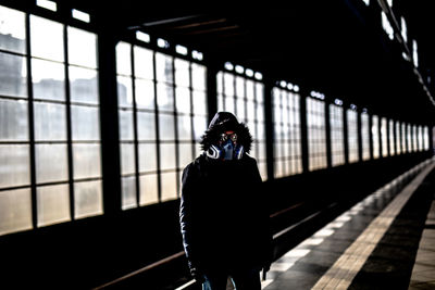 Person with mask standing on railroad station platform after corona virus outbrake in berlin on marc