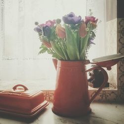 Close-up of flower vase on table at home